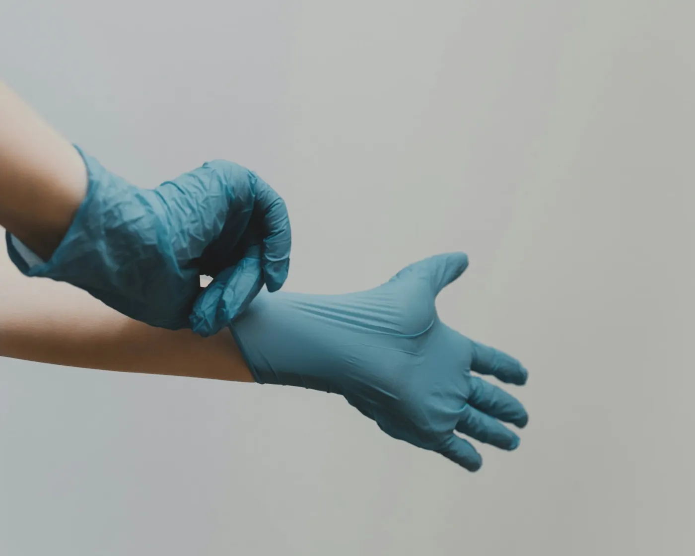 Clinician gloving up before a shift